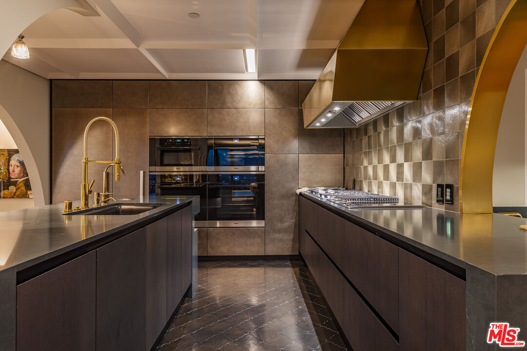 10727 Wilshire Boulevard, Unit 1805 Los Angeles, CA 90024 - Photo 28 of 34 a kitchen with stainless steel appliances granite countertop a sink and stove
