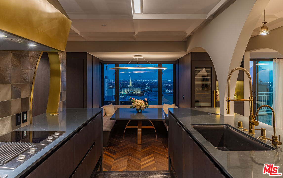 10727 Wilshire Boulevard, Unit 1805 Los Angeles, CA 90024 - Photo 29 of 34 a dining room with furniture and a large window