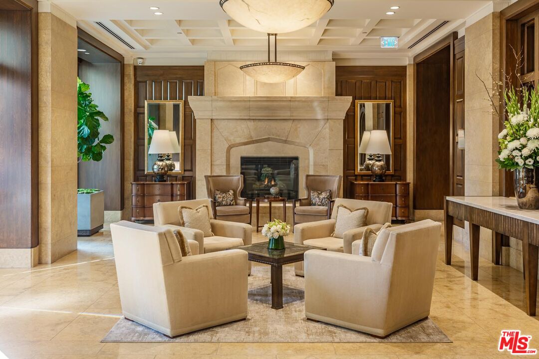 10727 Wilshire Boulevard, Unit 1805 Los Angeles, CA 90024 - Photo 4 of 34 a living room with fireplace furniture and a potted plant