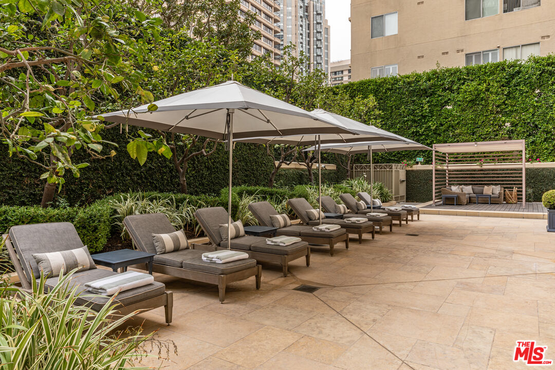 10727 Wilshire Boulevard, Unit 1805 Los Angeles, CA 90024 - Photo 6 of 34 a view of a patio with a table and chairs under an umbrella