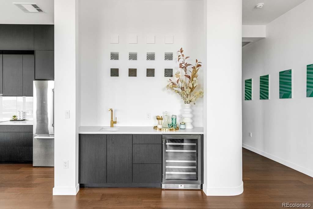 3520 Chestnut Place, Unit PH1201 Denver, CO 80216 - Photo 11 of 44 a kitchen with a sink and a refrigerator