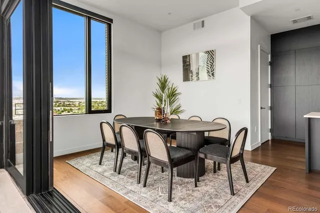 a view of a dining room with furniture window and wooden floor
