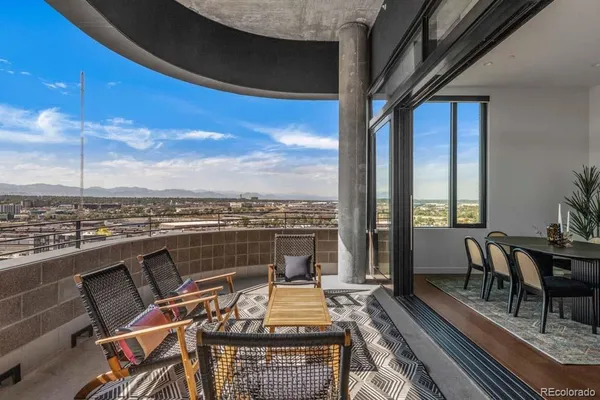 a view of a roof deck with furniture