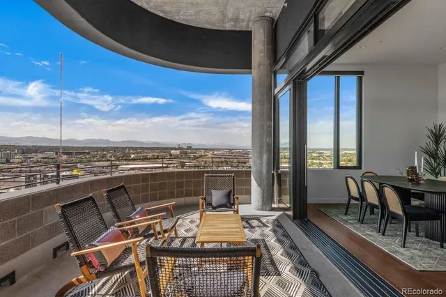 a view of a roof deck with furniture