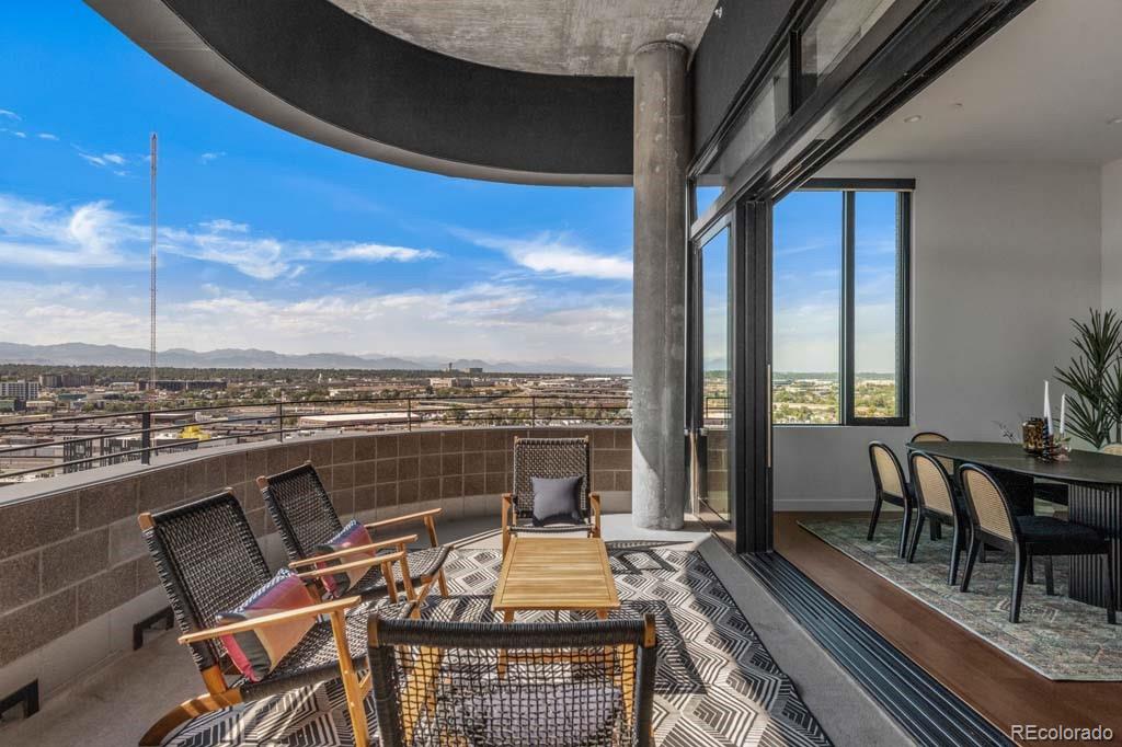3520 Chestnut Place, Unit PH1201 Denver, CO 80216 - Photo 17 of 44 a view of a balcony with wooden floor and furniture