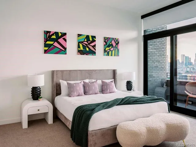 a bedroom with a bed and large windows