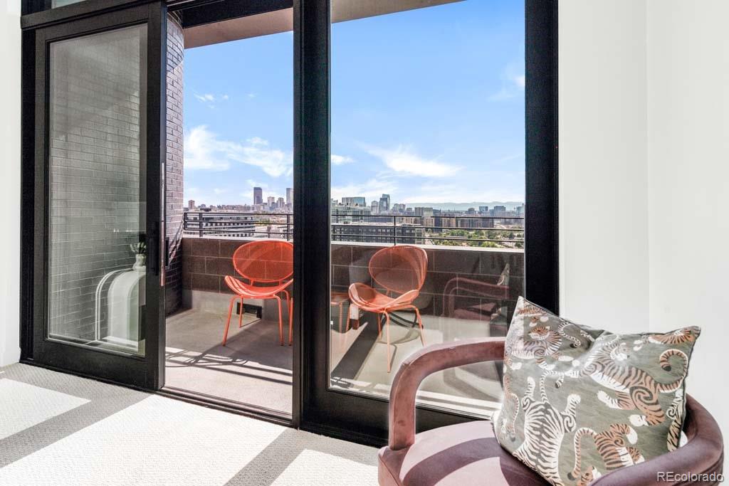 3520 Chestnut Place, Unit PH1201 Denver, CO 80216 - Photo 21 of 44 a view of a balcony with chair and glass door