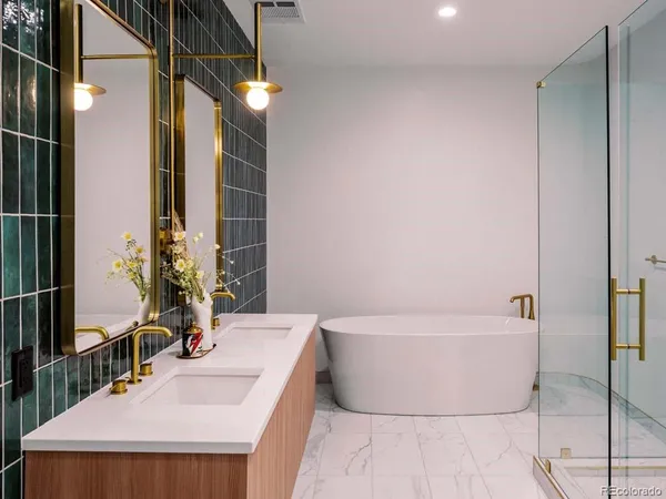 a bathroom with a bathtub a sink and a mirror
