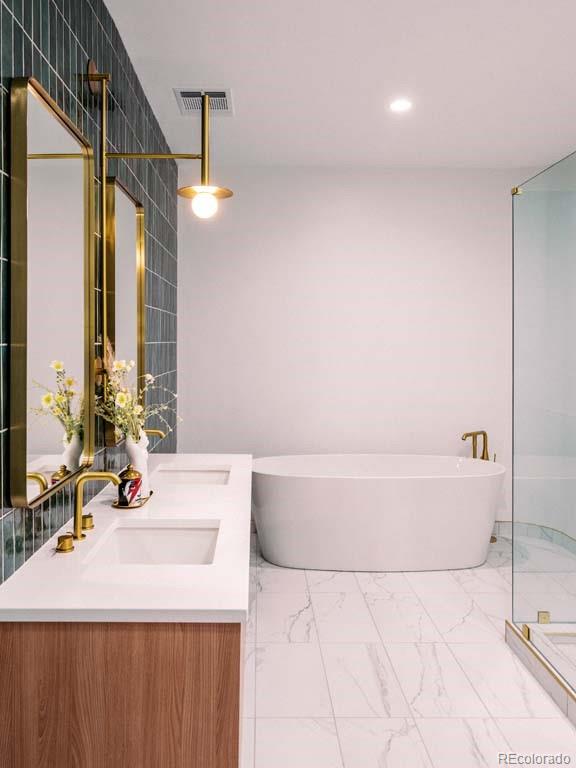 3520 Chestnut Place, Unit PH1201 Denver, CO 80216 - Photo 23 of 44 a bathroom with a bathtub a sink and a mirror