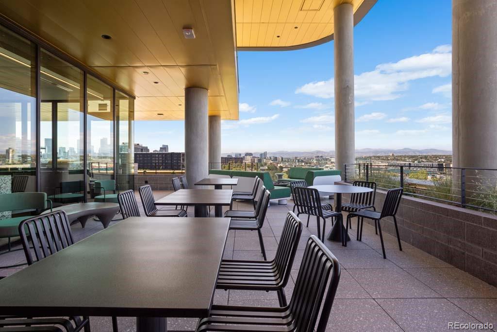 3520 Chestnut Place, Unit PH1201 Denver, CO 80216 - Photo 32 of 44 a view of a city from a dining room with furniture