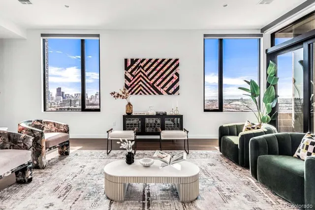 a living room with furniture potted plant and a window