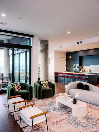 a living room with furniture a rug and a large window