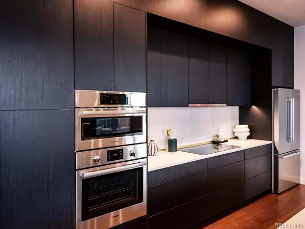 a kitchen with a sink appliances and cabinets