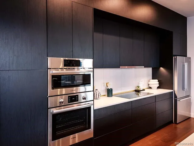 a kitchen with a sink appliances and cabinets