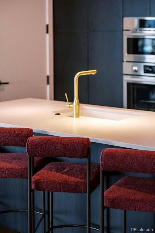 3520 Chestnut Place, Unit PH1201 Denver, CO 80216 - Photo 9 of 44 a bedroom with a bed and a television