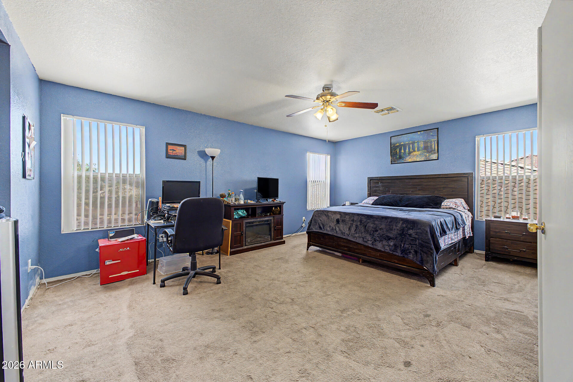 2607 West Bloch Road Phoenix, AZ 85041 - Photo 17 of 34 a bedroom with a bed gym equipment and a desk