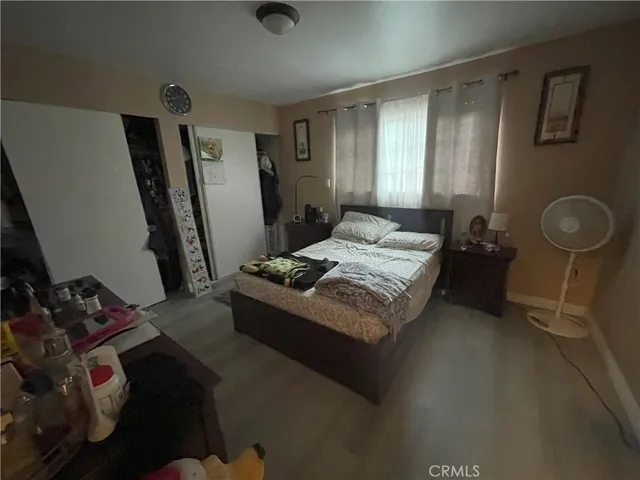 a living room with hard wood floor and a mirror