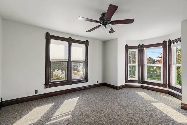 a view of a livingroom with a ceiling fan and a large window