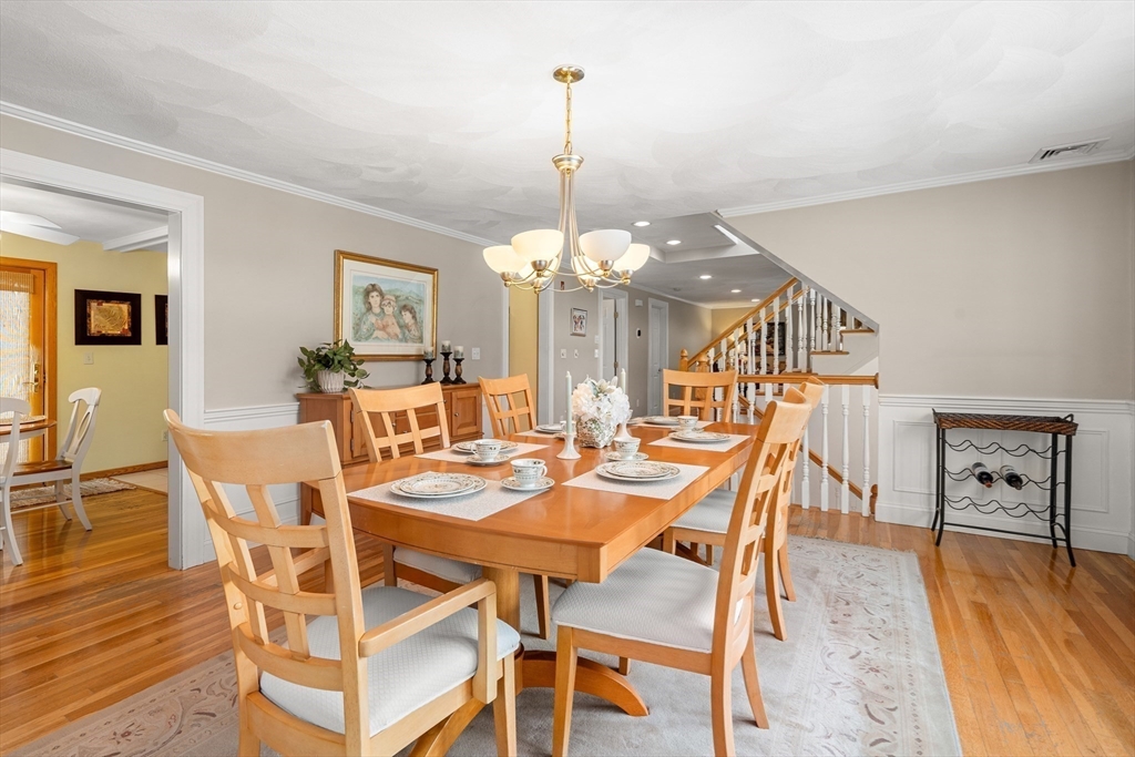 7 Belfast Road Peabody, MA 01960 - Photo 11 of 37 a dining room with wooden floor a chandelier a wooden table and chairs