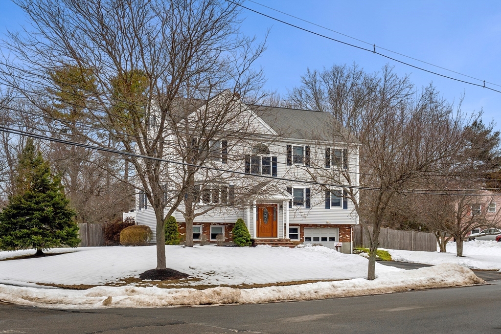 7 Belfast Road Peabody, MA 01960 - Photo 2 of 37 a view of a white house with a snow on the road