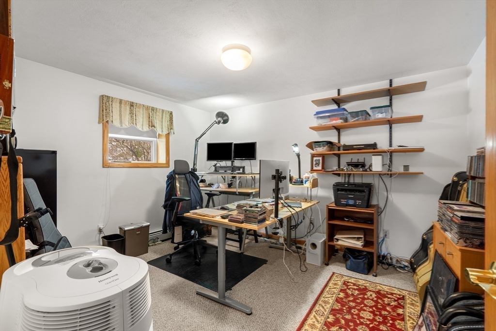 7 Belfast Road Peabody, MA 01960 - Photo 31 of 37 a view of a workspace with furniture and a bedroom