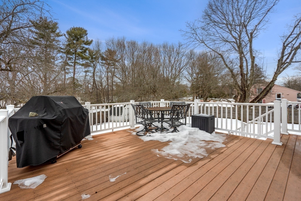 7 Belfast Road Peabody, MA 01960 - Photo 35 of 37 a view of a roof deck with table and chairs and wooden floor