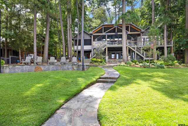 a front view of house along with deck and outdoor seating