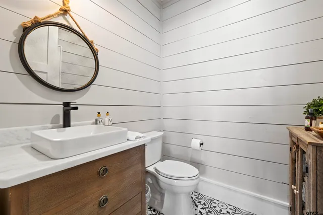 a large kitchen with a table chairs and a ceiling fan
