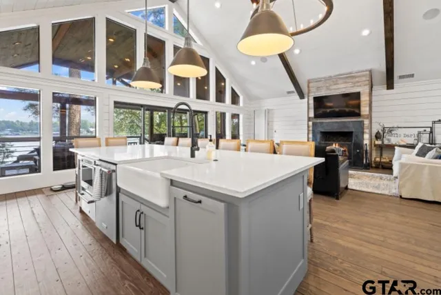 a kitchen with stainless steel appliances a stove a sink a refrigerator and cabinets