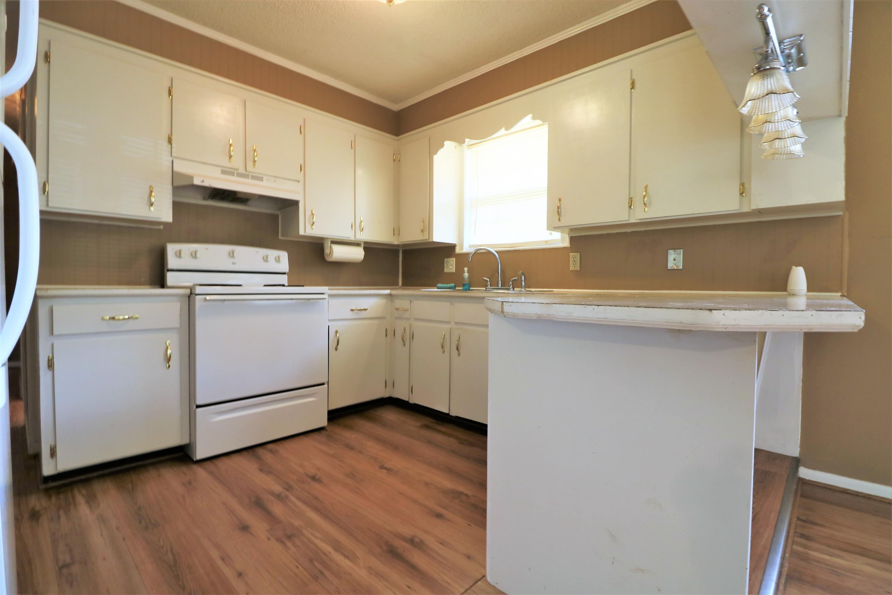 1860 Pettis Road Chipley, FL 32428 - Photo 6 of 16 a kitchen with a sink cabinets stainless steel appliances and a window
