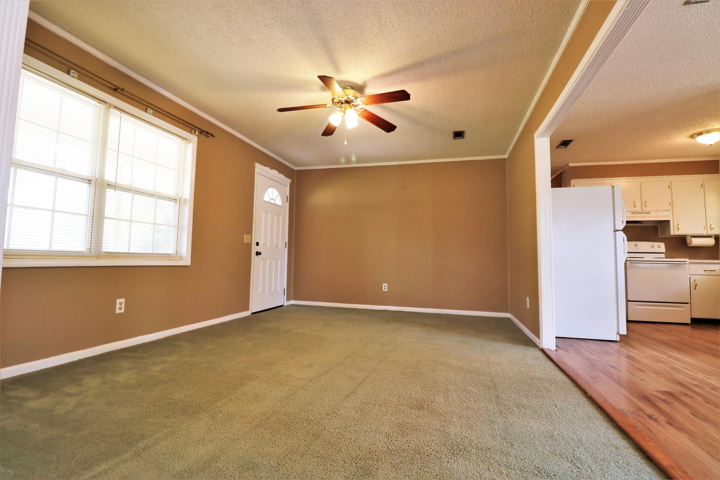 1860 Pettis Road Chipley, FL 32428 - Photo 8 of 16 an empty room with windows and ceiling fan