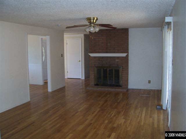 2265 West 7th Street Reno, NV 89503 - Photo 2 of 8 a view of a livingroom with wooden floor a fireplace and window