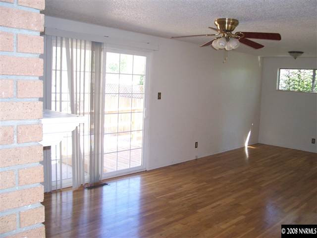 2265 West 7th Street Reno, NV 89503 - Photo 3 of 8 a view of an empty room with wooden floor and a window