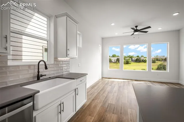 a kitchen with a sink and wooden floor