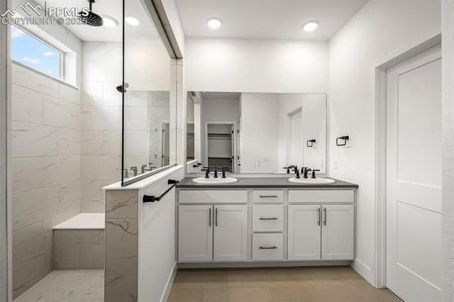 a bathroom with a granite countertop sink a toilet and a mirror