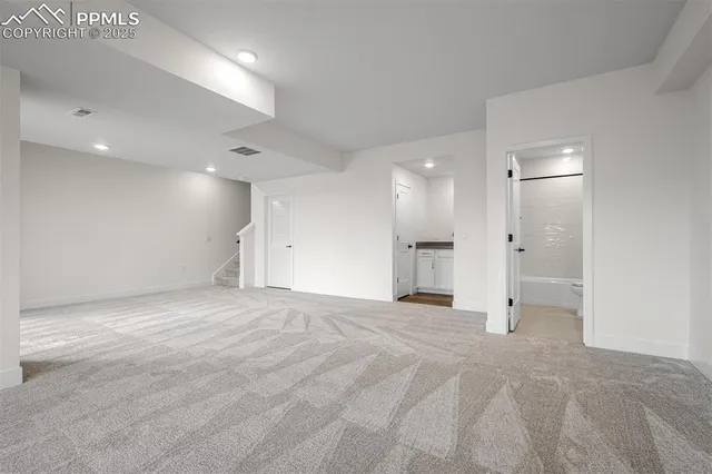 a kitchen with granite countertop white cabinets and a sink