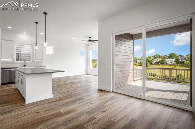 a view of kitchen and hall with wooden floor