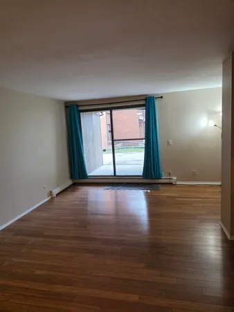 an empty room with wooden floor and closet