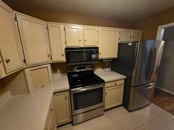 a kitchen with cabinets and steel stainless steel appliances