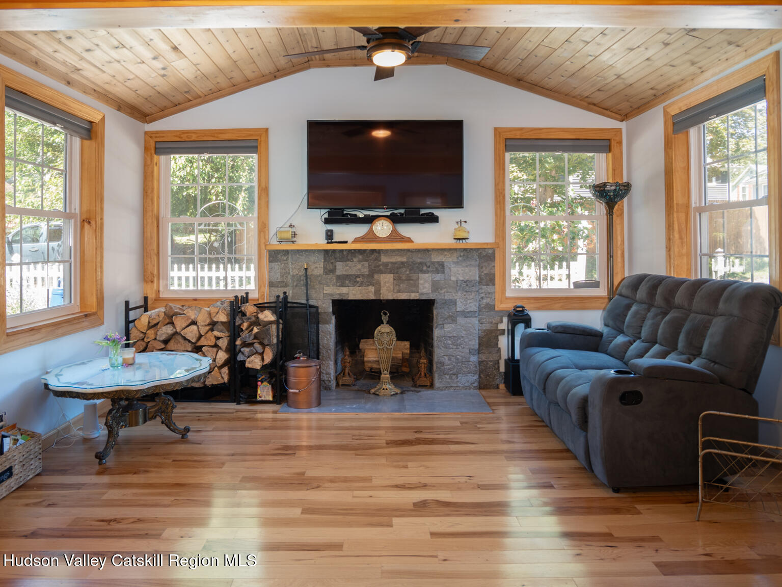 16 Robin Road, Unit GO UP ROBIN ROAD NOT DOWN Copake, NY 12521 - Photo 15 of 32 a living room with furniture a flat screen tv and a fireplace