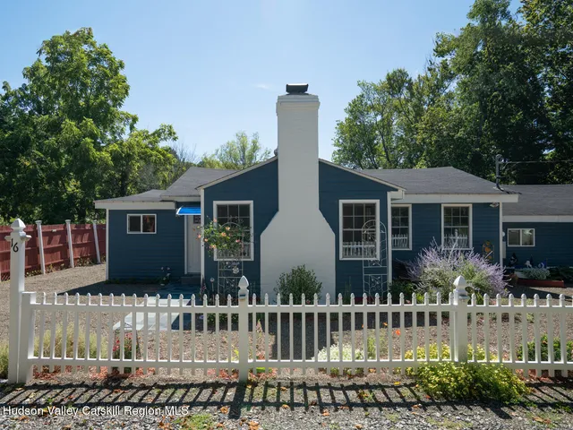 a front view of house with a garden