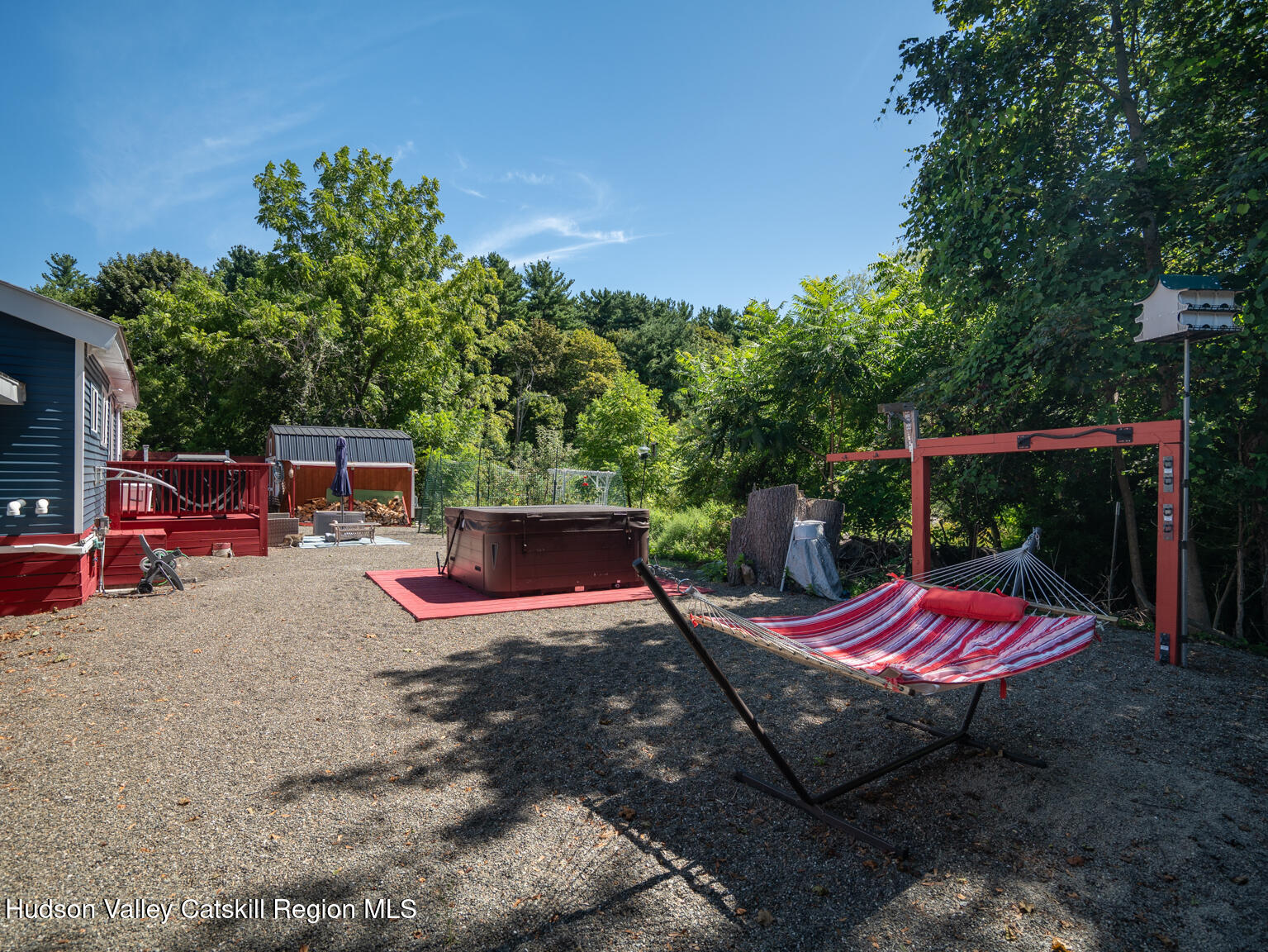 16 Robin Road, Unit GO UP ROBIN ROAD NOT DOWN Copake, NY 12521 - Photo 6 of 32 a backyard view of a house with trampoline fire pit tables and chairs