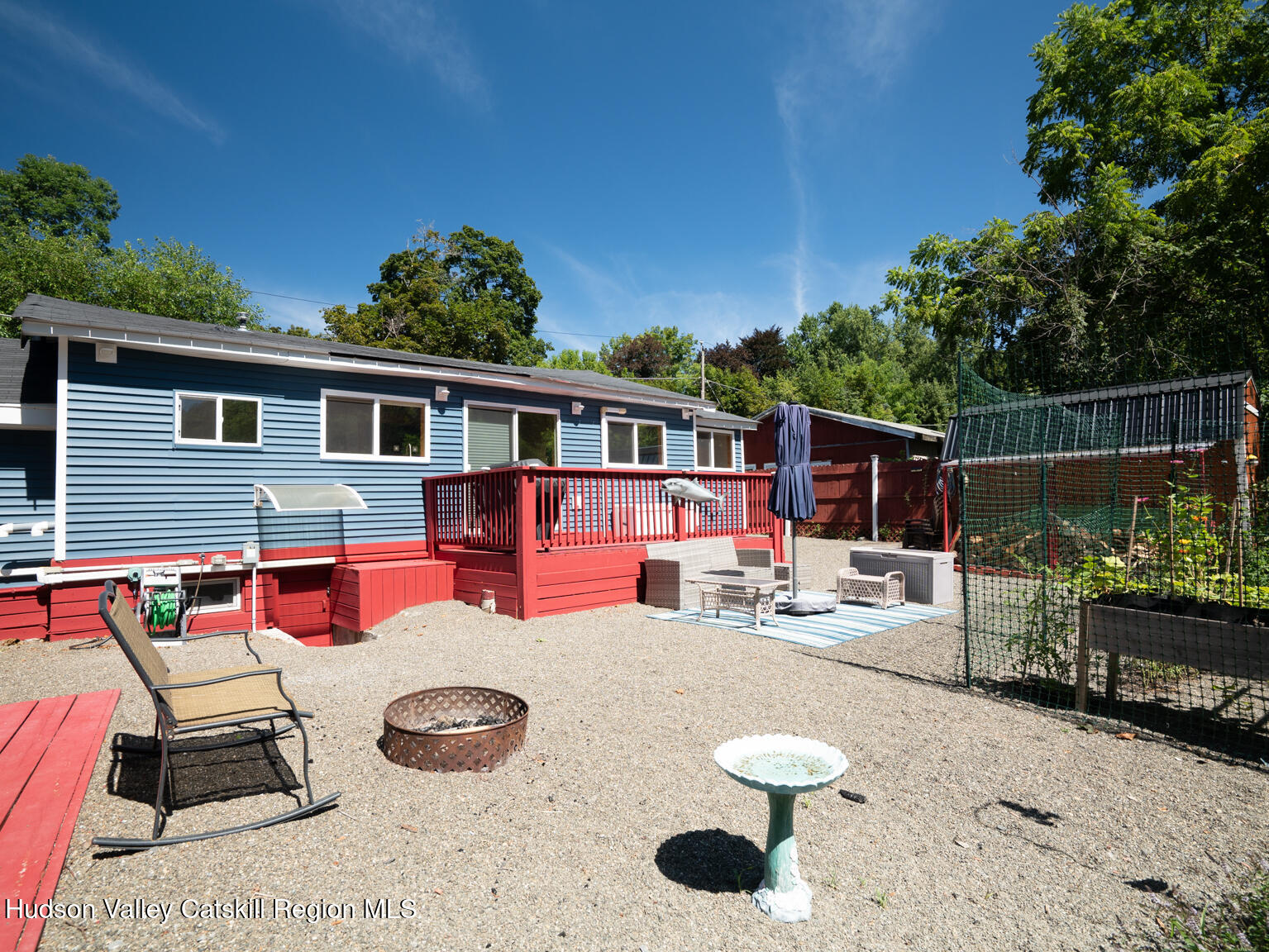 16 Robin Road, Unit GO UP ROBIN ROAD NOT DOWN Copake, NY 12521 - Photo 8 of 32 a backyard of a house with fire pit and outdoor seating