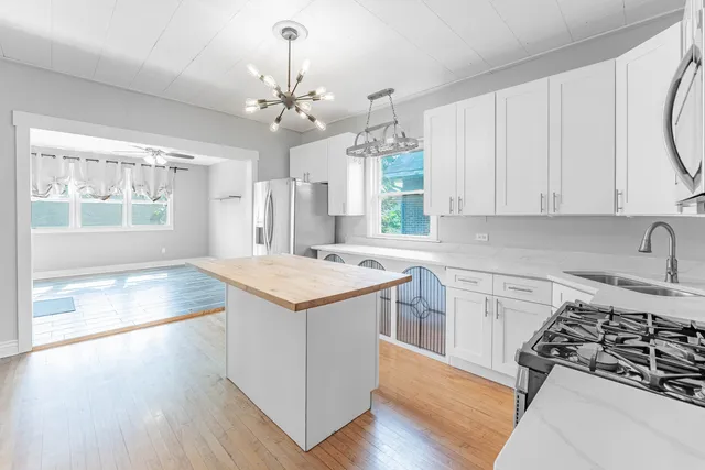 a kitchen with a stove a sink and a refrigerator