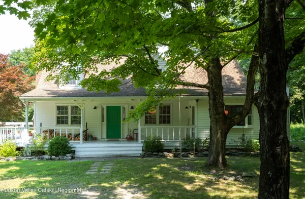 front view of a house with a tree in a yard