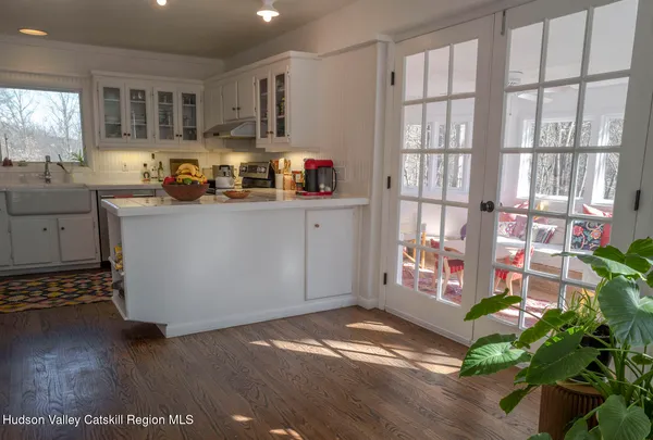 a kitchen with granite countertop a stove a sink and a window