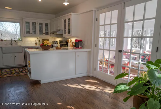 a kitchen with granite countertop a stove a sink and a window