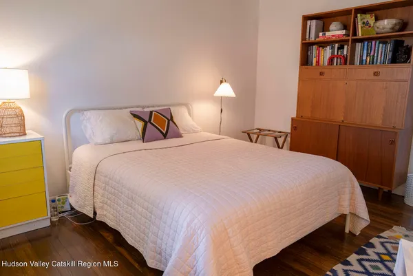 a bedroom with a bed and a book shelf