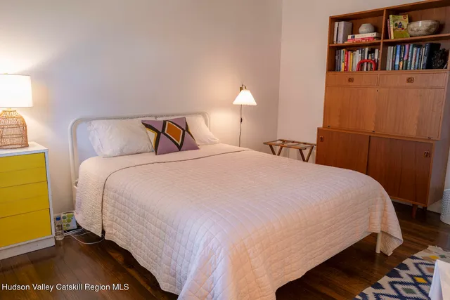 a bedroom with a bed and a book shelf