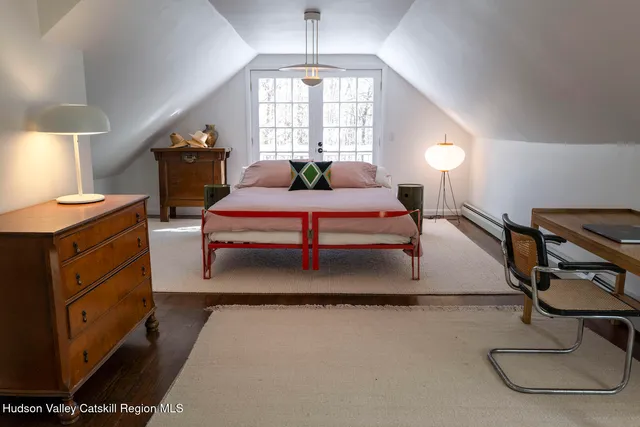 a living room with furniture a window and a chandelier